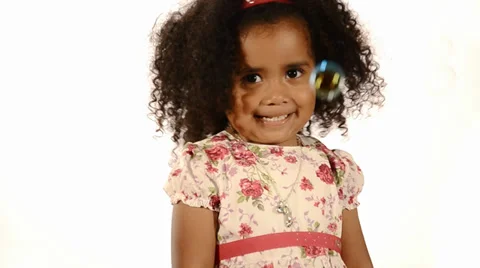 Funny mixed race black and brazilian little girl isolated with bubbles floating Stock Footage 33108161