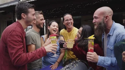 Funny Multicultural Group Of Friends Enjoying Evening Drinks In Bar. People Stock Footage 173550186