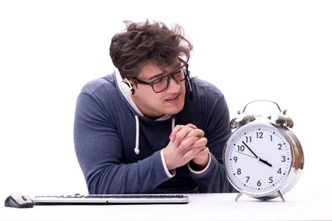 Funny nerd call center operator with giant clock 写真素材
