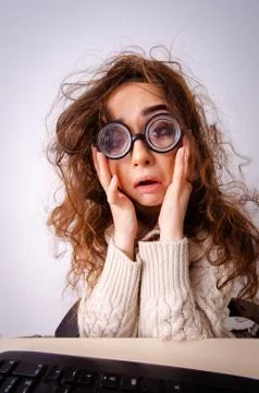 Funny nerd girl working on computer 스톡 사진
