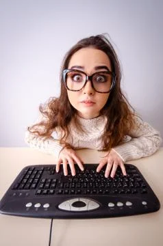 Funny nerd girl working on computer 스톡 사진