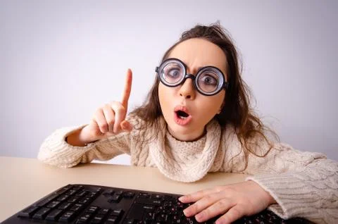 Funny nerd girl working on computer Foto stock
