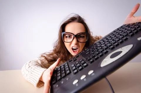The funny nerd girl working on computer Stockfoto's