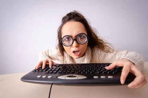 The funny nerd girl working on computer 写真素材
