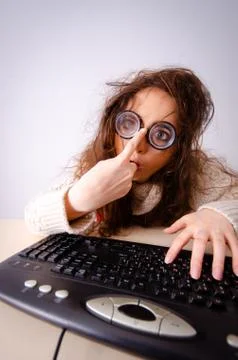 The funny nerd girl working on computer Stockfoto's