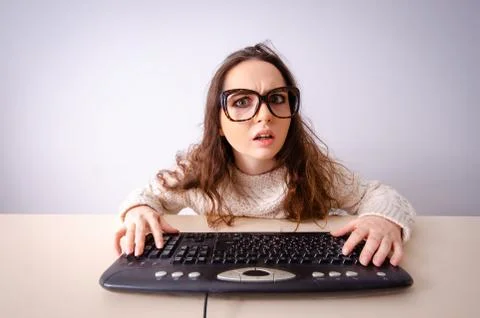 Funny nerd girl working on computer 스톡 사진