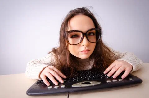 Funny nerd girl working on computer Stock Photos