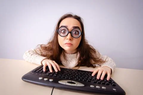 Funny nerd girl working on computer 스톡 사진