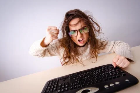 Funny nerd girl working on computer 스톡 사진