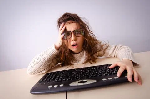 Funny nerd girl working on computer 스톡 사진