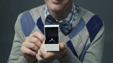 Funny nerd guy giving an engagement ring to his girlfriend Video stock 90641161
