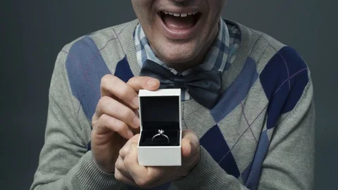 Funny nerd guy giving an engagement ring to his girlfriend Video stock 90641217