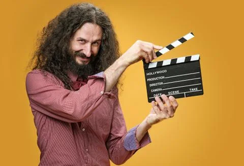 Funny nerd holding a clapperboard Stock Photos