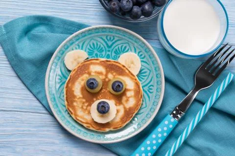 Funny pancake in a shape of teddy bear, food for kids idea, top view Stock Photos