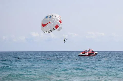 Funny parasail wing pulled by a boat. Sea summer recreation. Summer water bea Фото