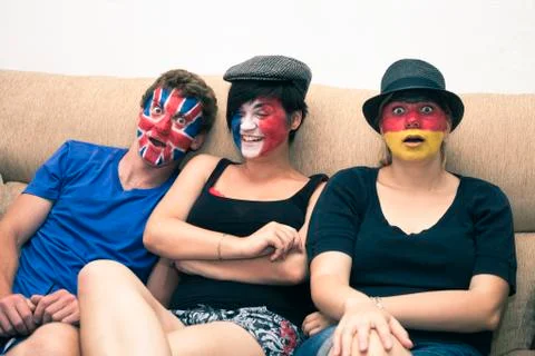 Funny people with painted flags on faces Stock Photos