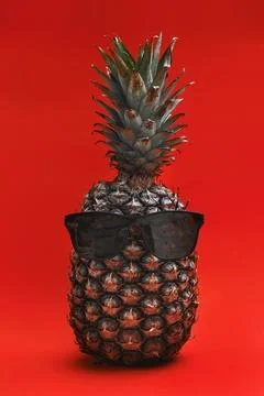 Funny pineapple in sunglasses. Flat lay on red paper background. pineapple .. Stock Photos