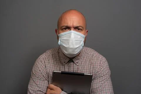 Funny Portrait of a keep working bearded man with tablet in hands in a gauze  Stock Photos