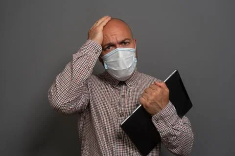 Funny Portrait of a keep working bearded man with tablet in hands in a gauze  Stock Photos