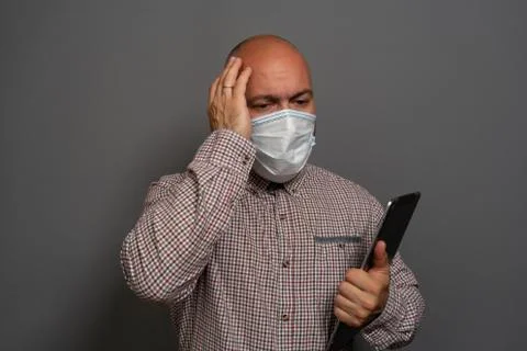 Funny Portrait of a keep working bearded man with tablet in hands in a gauze  Stock Photos