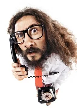 Funny portrait of a nerd talking on the phone Stock Photos