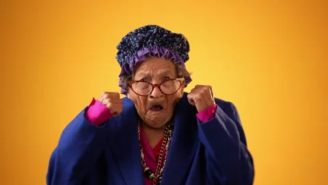 Funny portrait of toothless elderly senior old woman with wrinkled skin having Stock Footage 254033888