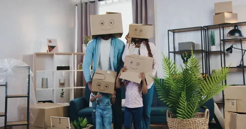 Funny positive good-looking modern family with two small kids hiding their heads Stock Footage 150706773