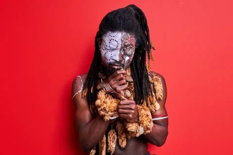 Funny primitive african native guy trying to use modern cutlery Stock Photos