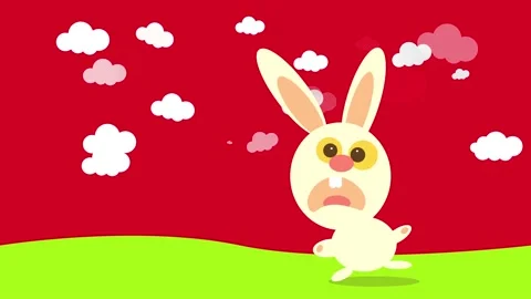 Funny rabbit rushing to a place yelling like crazy through a vast green meadow Stock Footage 130347947