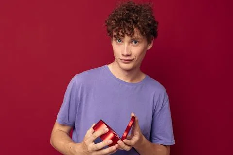 Funny red-haired guy with curly hair a gift like a heart Stock Photos