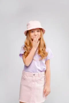 Funny red-haired long-haired girl in daily clothes (skirt, t-shirt) Stock Photos