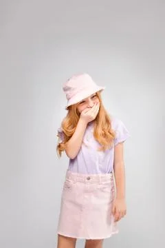 Funny red-haired long-haired girl in daily clothes (skirt, t-shirt) Stock Photos