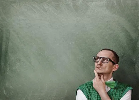 Funny retro nerd thinking over the chalkboard background with copy space Stock Photos