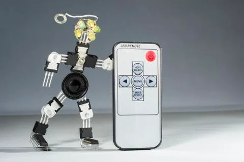 The funny robot from microcircuits and transistors holds remote control Stock Photos