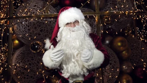 Funny Santa Claus is talking to the camera, wishing a Merry Christmas and a Stock Footage 167101838