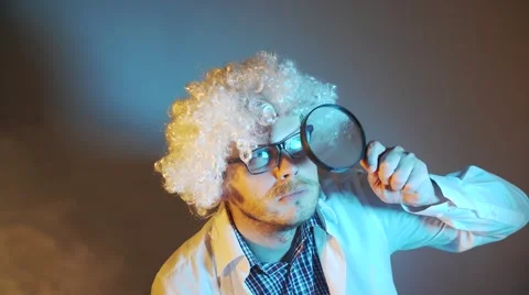 Funny scientist, like Einstein with a magnifying glass Stock Footage 68373117