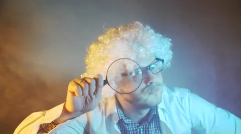 Funny scientist, like Einstein with a magnifying glass Stock-Footage 68373357