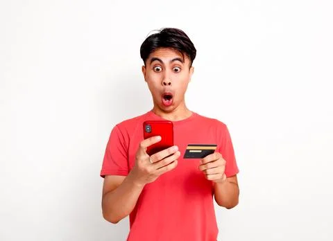 Funny shocked customer using and looking at smartphone while holding credit.. Stock Photos