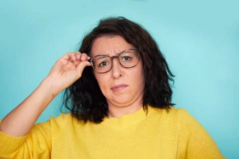 Funny shocked face. frames trying eyeglasses. girl holding glasses standing on Stock Photos