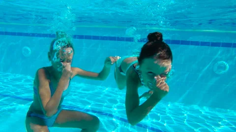 Funny sisters jump in cool pool. Stock Footage 233120583