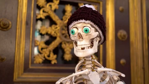 Funny skeleton with hat in front of golden wood door Stock Footage 263645326