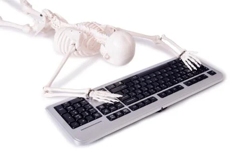 Funny Skeleton working on computer Stock Photos