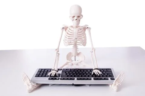Funny Skeleton working on computer Stock Photos