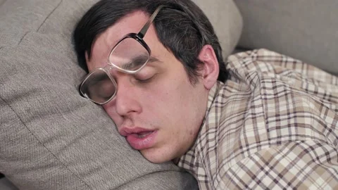 Funny sleeping man on the sofa Stock Footage 145020787