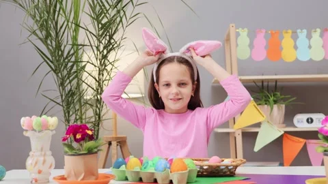 Funny smiling cheerful brown haired little girl wearing pink shirt playing with Vídeo Stock 293239505