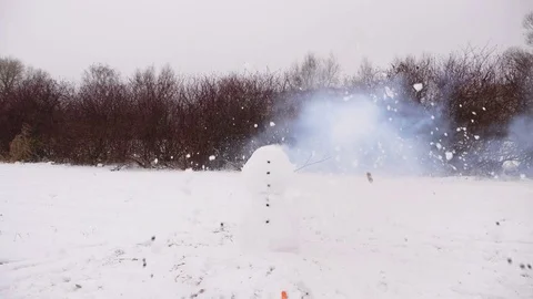 Funny smiling face of snowman, head blowing up by cracker detonation Video stock 84315803