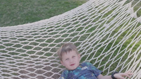 Funny smiling kid on hammock play outdoors	 Stock Footage 170188660