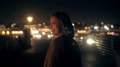 Funny smiling young millenial woman running on night embankment steadicam Stock Footage 126246947