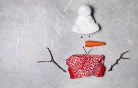 Funny snowman made with different elements on light grey marble background, f 스톡 사진