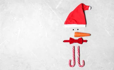 Funny snowman made with different elements on light grey marble background, f 스톡 사진
